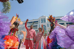 Couple Celebrates with Colorful Dancers