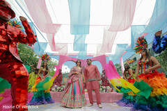 Colorful Draped Decor with Performers and a Couple in Pink Attire