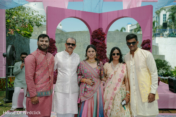 Family Poses in Front of Pink Arch Decor