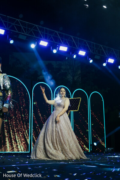 Glittering Gown Performance on a Dynamic Stage with Light Show