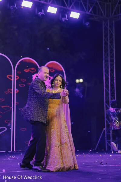 Couple's Joyful Dance at a Vibrant South Asian Reception