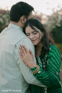 Bride Embraces Partner in Green Bandhani Attire