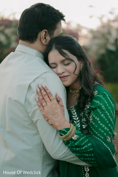 Bride Embraces Partner in Green Bandhani Attire