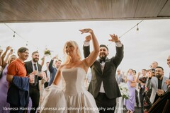 Joyful Bride and Groom Entrance in Classic White Gown and Black Suit