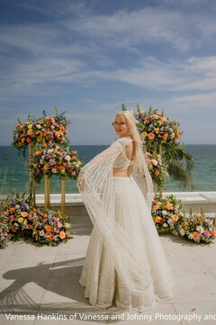 Bride in White Lehenga with Flowing Sleeves Posing Outdoors
