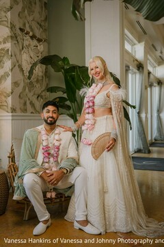 Couple in Off-White and Mint Green Wedding Attire with Floral Garlands