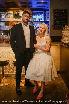 Couple Poses in Bar with White Dress and Black Suit