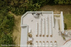 Rooftop Wedding Ceremony Setup with White Chairs and Floral Aisle Decor