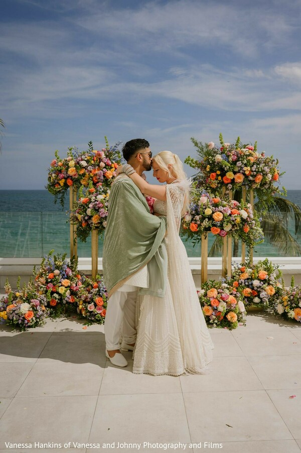 couple,portrait,balcony,floral decor,white lehenga,sage green kurta,outdoor,ocean view