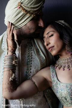 Intimate Couple's Portrait: Light Green Attire and Intricate Mehndi Details