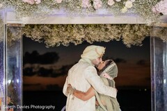 Romantic Sunset Kiss Under Floral Archway