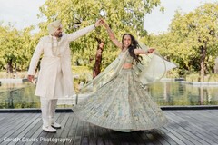 Joyful Twirl: Couple Poses Outdoors in Elegant Wedding Attire