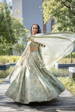 Bride Poses in Sage Green Floral Lehenga with Flowing Dupatta