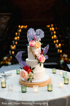 Three-Tier Wedding Cake with Floral Accents and Initials A & R