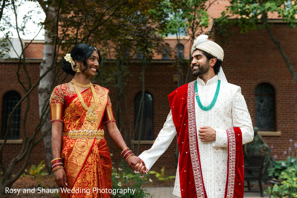 indian wedding,wedding portraits,red lehenga,gold necklace,gold earrings,white sherwani,red dupatta,groom fashion,bridal fashion,outdoor wedding,couple pose,wedding photography
