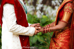 Couple Holding Hands in Red and Gold Attire