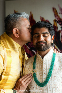 Groom's Tender Moment: Fatherly Kiss & Emerald Necklace Detail