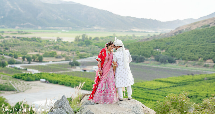 wedding,red lehenga,white sherwani,mountain wedding,outdoor portraits,scenic backdrop,wedding photography,couple portraits,traditional attire,valley views