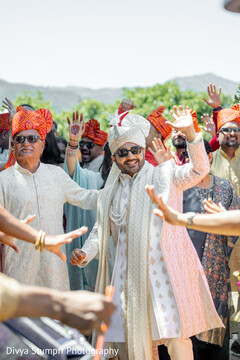 Groom's Joyful Entrance in White Sherwani with Colorful Turbans