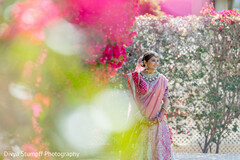 Bride in Pink Sari with Statement Necklace in Garden Setting