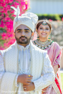 Joyful Bride in Pink Lehenga with Groom in Ivory Sherwani