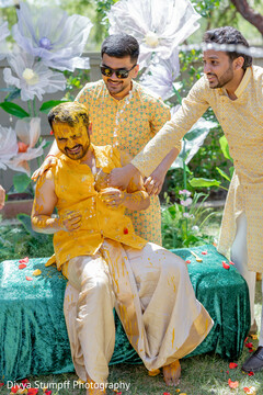 Groom in Yellow Top and Dhoti During Pre-Wedding Celebration