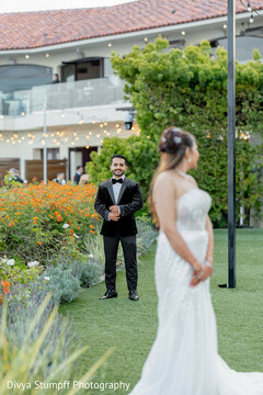 Groom Looks at Bride in White Gown