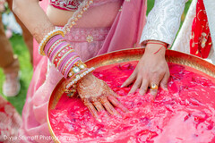 Bride's Hand with Mehndi and Bangles in Red Paste