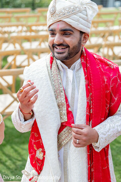 Groom's Radiant Smile in Ivory Sherwani and Red Dupatta