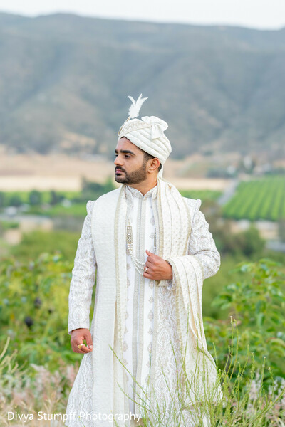 groom fashion,white sherwani,embroidered sherwani,turban,outdoor portrait,south asian groom,wedding attire,traditional menswear,wedding fashion,groom style