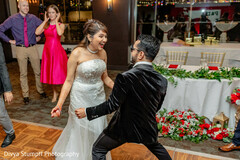 Joyful Couple Dances at Wedding Celebration