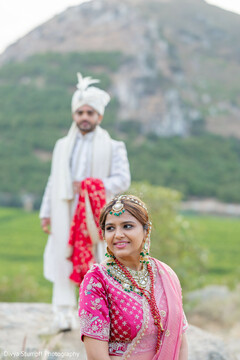 Bride in Pink Embroidered Lehenga Blouse and Groom in White Sherwani