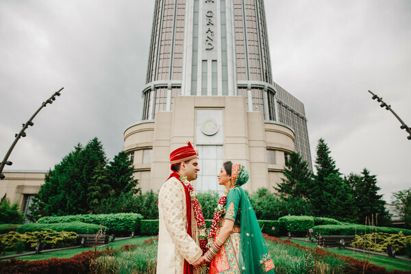 couple,wedding,portrait,building,outdoor,fashion,green lehenga,cream sherwani