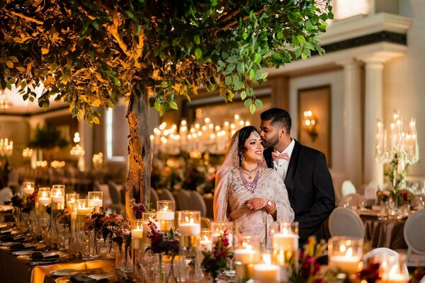 reception,candlelit decor,lehenga,dark suit,elegant decor,wedding reception,chandeliers