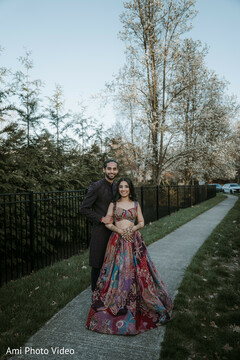 Couple in Patterned Lehenga and Dark Sherwani for Outdoor Pre-Wedding Shoot
