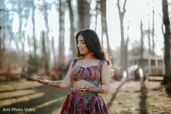 Woman Displays Intricate Mehndi Designs on Hands in Outdoor Portrait