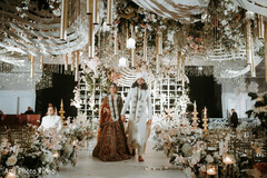 Couple Walks Away From Camera Amidst Elaborate Floral and Gold Decor