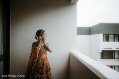 Bride's Elegant Getting Ready Moment in Terracotta Lehenga