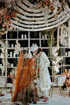 Bride and Groom in White and Peach Floral Decor