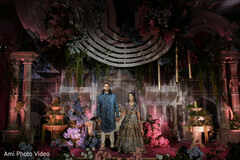 Couple on Elaborate Stage with Floral Arch and Intricate Backdrops