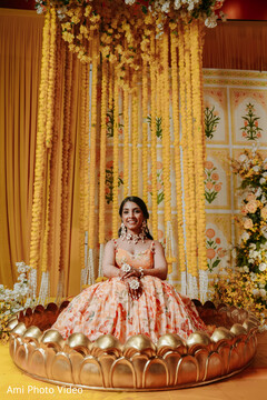 Bride in Peach Floral Lehenga with Marigold Garlands