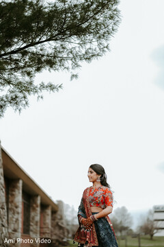 Bride in Embroidered Blouse and Blue Lehenga Under a Tree