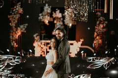 Couple Poses Amidst Dramatic Black and Gold Decor