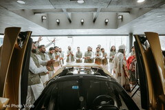 Groom's Grand Entrance with a Gold Sports Car & Groomsmen