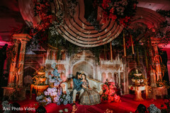 Regal Reception Stage with Romantic Floral Decor and Architectural Elements