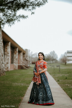 Bride in Patterned Dark Blue Lehenga and Red Blouse