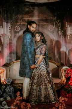 Couple in Embroidered Blue Sherwani and Multi-Color Lehenga