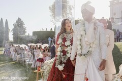 Couple in Floral Garlands Walking Outdoors
