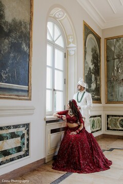 Regal Couple Portrait with Deep Red Lehenga and White Sherwani