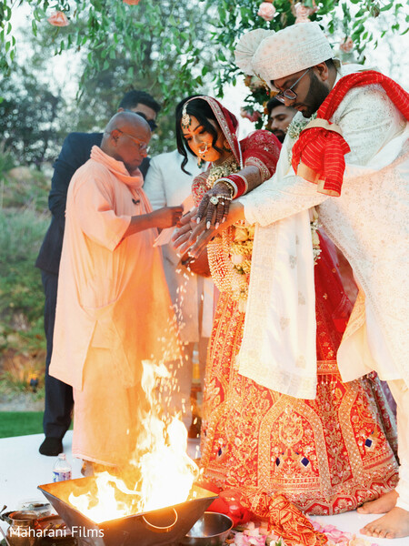 wedding ceremony,red lehenga,off-white groom attire,bridal fashion,groom fashion